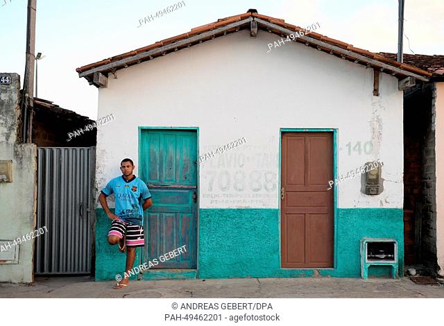 A man wearing a jersey of British Premier League club Manchester City stands in front of a house in a village near Porto Seguro in Brazil, 09 June 2014