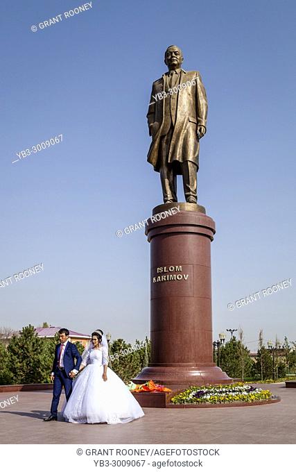 A â. . Just Marriedâ. . Couple Pose For A Wedding Photo Next To The Statue Of The Revered Former President Islam Karimov, Samarkand, Uzbekistan