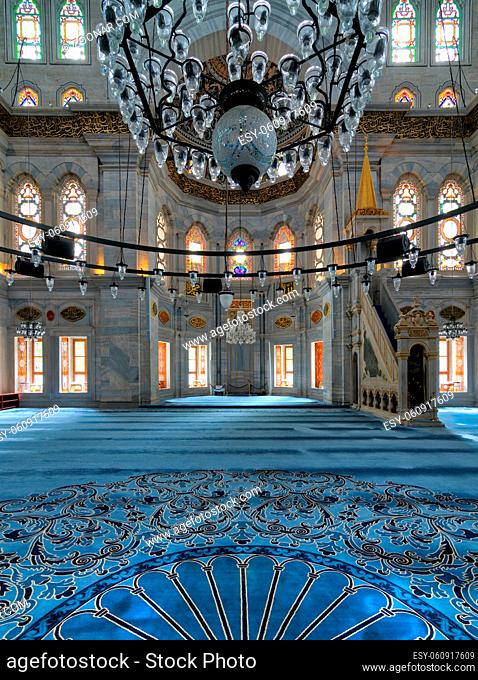Interior shot of Nuruosmaniye Mosque, an Ottoman Baroque mosque, overlooking niche (Mihrab) and marble minbar (Platform) facade with many colored stained glass...