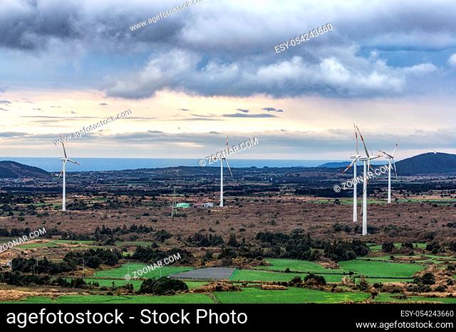 The view of wind turbines taken from Yongnuni Oreum during winter. Yongnuni Oreum is a famous volcanic crater in Jeju island, South Korea