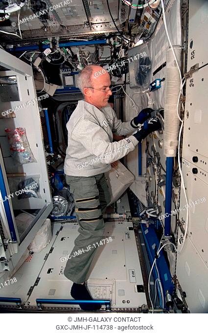 NASA astronaut Jeffrey Williams, Expedition 22 commander, works in the Destiny laboratory of the International Space Station while space shuttle Endeavour...