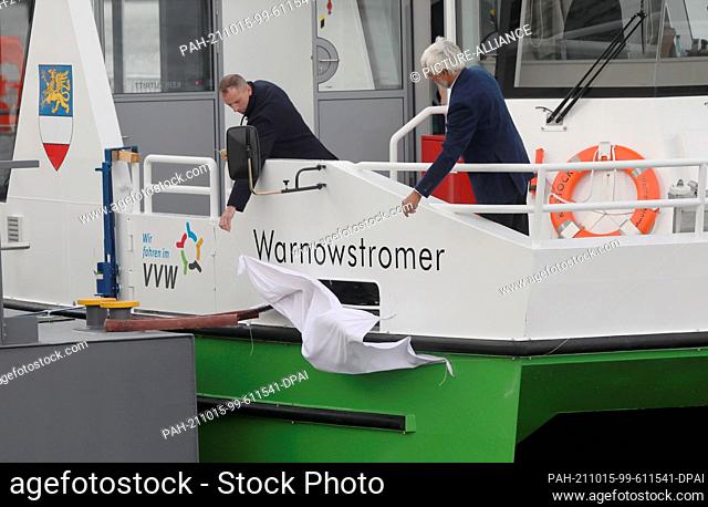 15 October 2021, Mecklenburg-Western Pomerania, Rostock: Crew members of the new electric passenger ferry ""Warnowstromer"" unveil the name of the ship shortly...