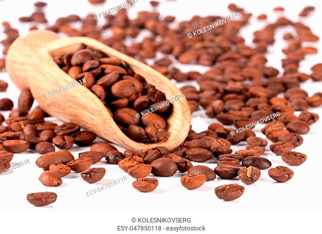 coffee beans in a wooden scoop isolated on white background