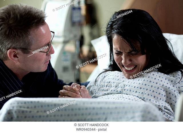 USA, Utah, Payson, Man watching wife giving birth