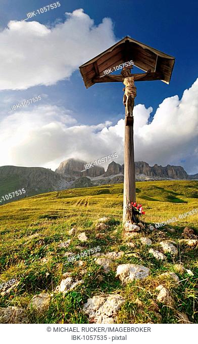 Cross at the Passo Pordoi with view of bizarre cloud formations and the Sella massif, province of Bolzano-Bozen, Italy, Europe