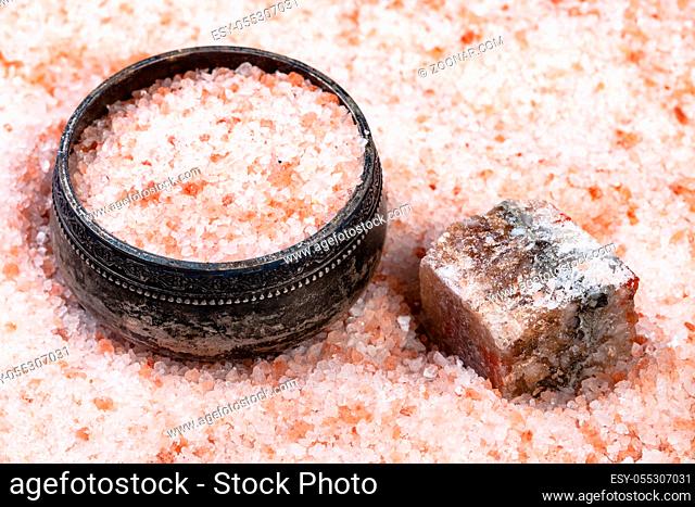 old silver salt cellar, raw natural pink Halite mineral and grained Himalayan Salt close up