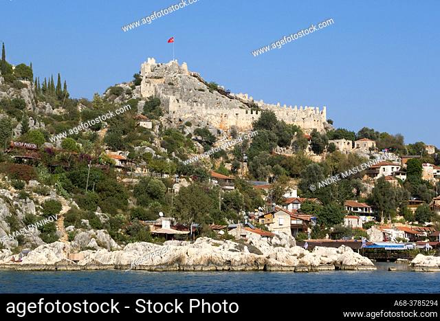 The picturesque village of Kaleköy with the castle perched at the top. Simena Castle. Turkey