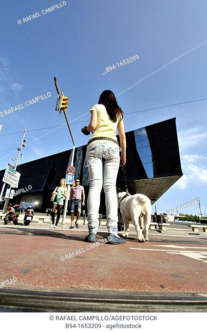 Girl with dog in front of Forum Building (aka Museu Blau de les Ciències Naturals), an architectural landmark in Barcelona designed by the Swiss architects...