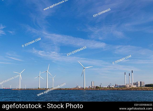 Photograph of wind power plants and industrial buildings in Copenhagen, Denmark