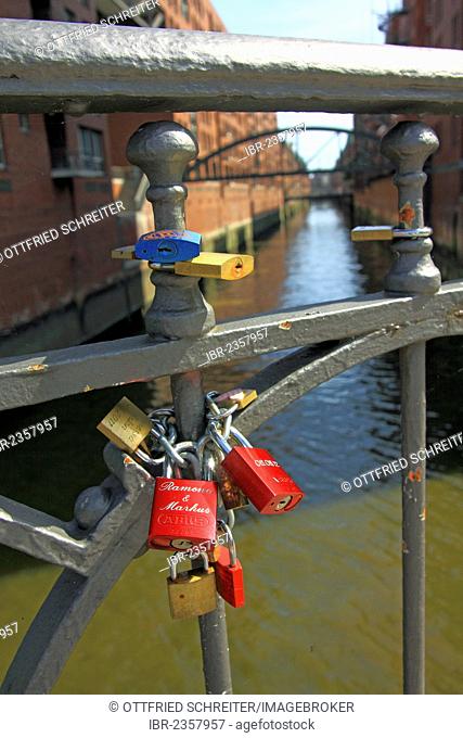 Love padlocks on a bridge railing, bridge over a canal in Speicherstadt, the historic warehouse district, Hanseatic City of Hamburg, Germany, Europe