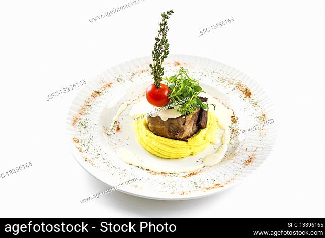 Grilled beef with herbs, tomatoes and potato mash