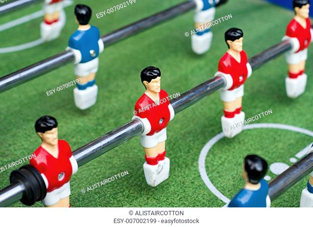 Red and blue table soccer players from top down