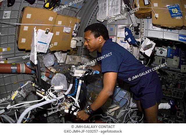 Astronaut Michael P. Anderson, STS-107 payload commander, prepares the Bicycle Ergometer for the Advanced Respiratory Monitoring System (ARMS) experiment in the...