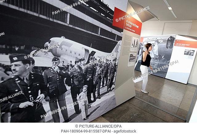 04.09.2018, Berlin: A woman walks through the exhibition ""Ein weites Feld - Der Flughafen Tempelhof und seine Geschichte"" (lit