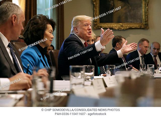 United States President Donald J. Trump talks to reporters while conducting a meeting of his cabinet in the Cabinet Room at the White House October 17