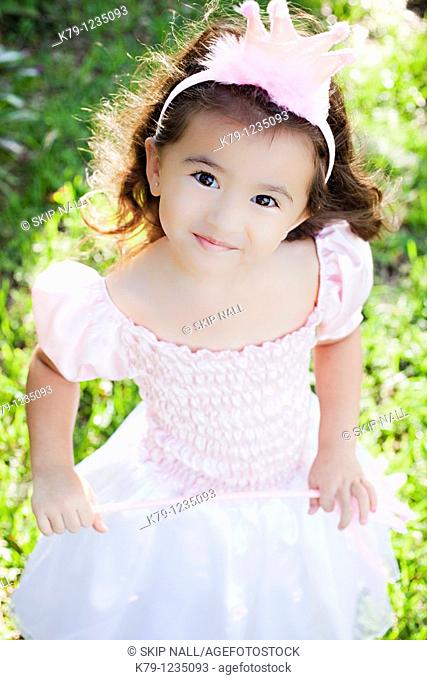 Little girl playing dress up as a princess