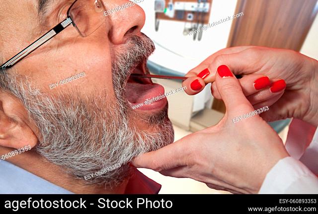 Adult with doctor in pediatrician office, medical examination of sore throat