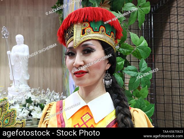 RUSSIA, MOSCOW - DECEMBER 12, 2023: A woman in traditional clothes is seen at a Kalmykia Republic Day event during the Russia Expo international exhibition and...