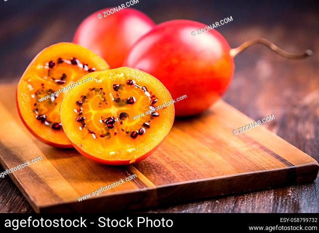 Organic tamarillo (tree tomato, Solanum betaceum) on cutting board
