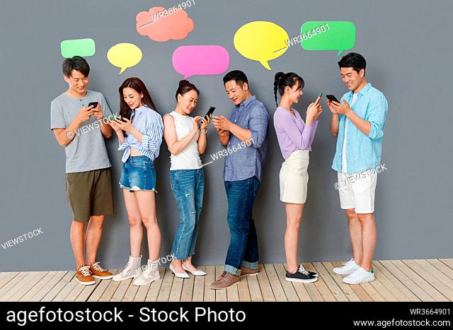 Happy couples use mobile phone chat software to communicate