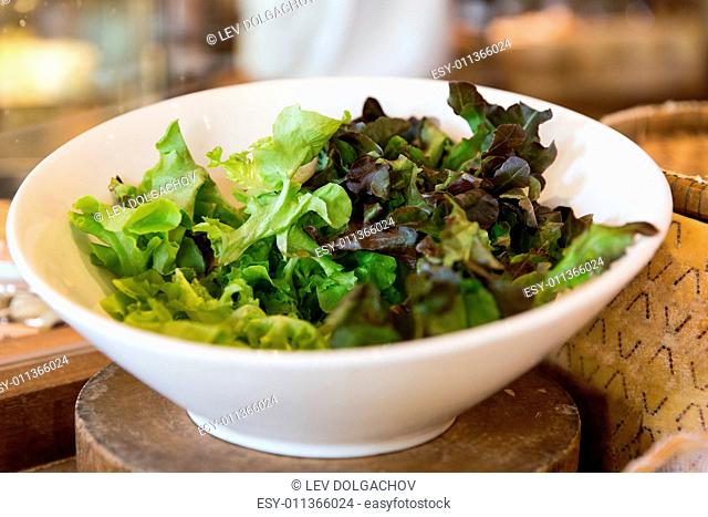 cooking, kitchen and food concept - bowl of green salad lettuce at asian restaurant