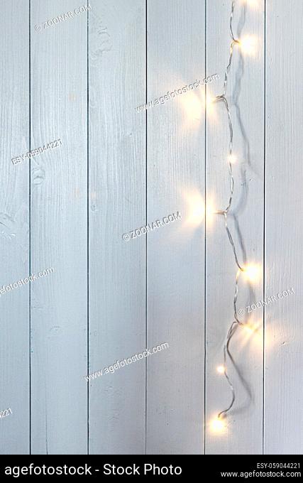 a row of small lights on a white wooden background