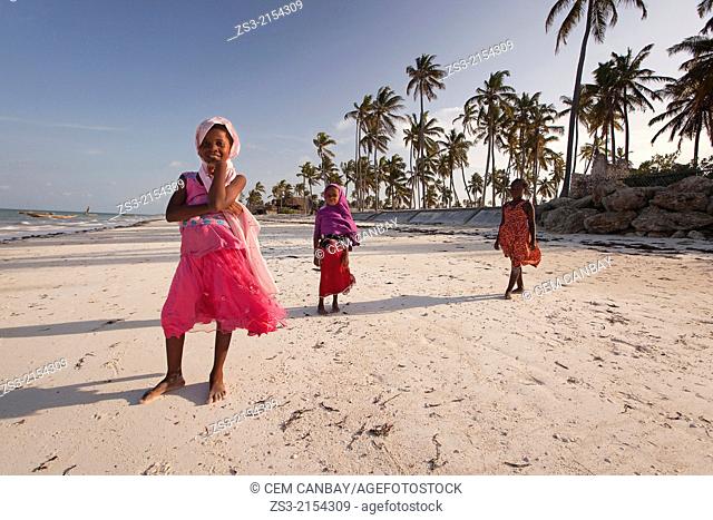 Young Muslim girls with colorful clothing posing on the beach, Jambiani, Zanzibar Island, Tanzania, Indian Ocean, East Africa