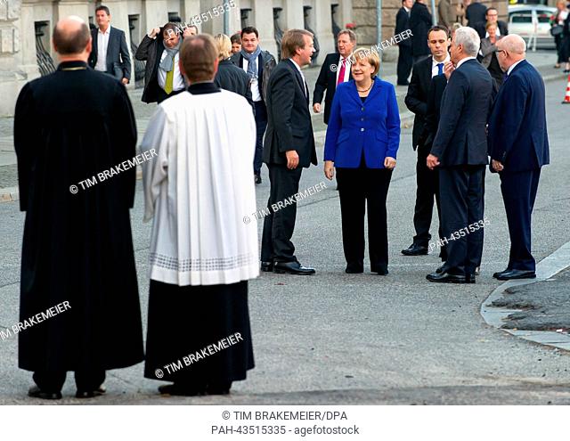German Chancellor Angela Merkel (CDU, 4-R) arrives for an ecumenical church service at St. Hedwig's Cathedral in Berlin, Germany, 22 October 2013