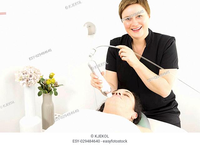 Close up of a customer lies with closed eyes for a diamond grinding, peeling, skin lift and drainage at a beauty and spa salon