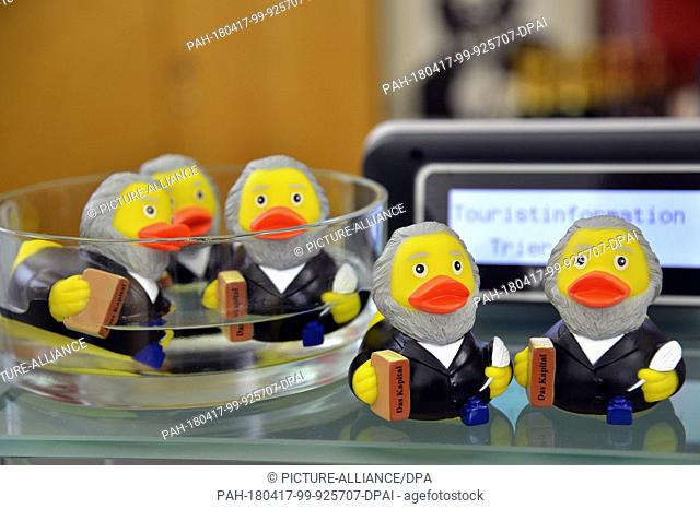10 April 2018, Trier, Germany: Karl Marx rubber ducks with grey bears for sale at the tourist information point in Trier
