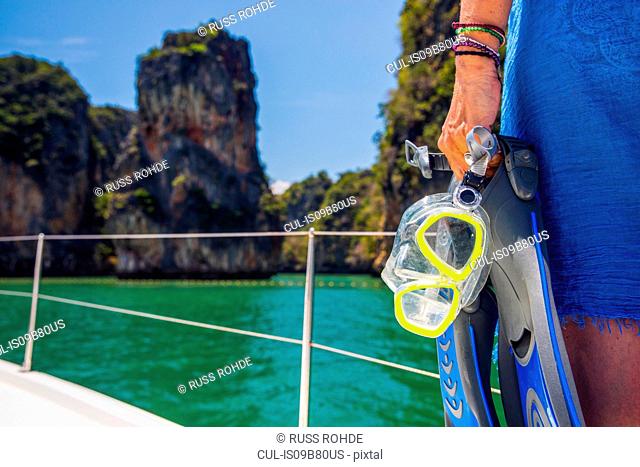 Cropped view of woman on yacht holding snorkel, Koh Hong, Thailand, Asia