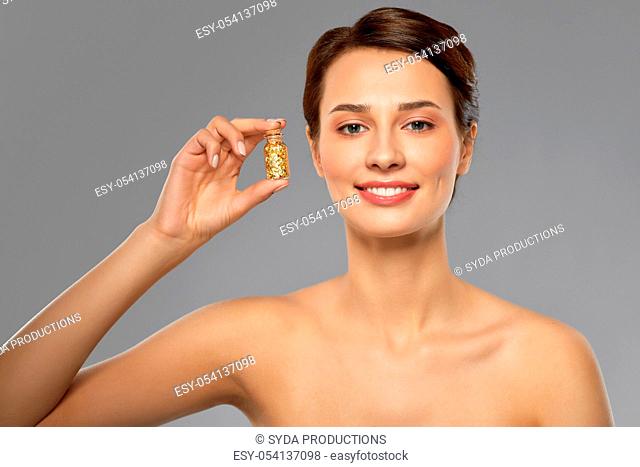 beautiful young woman with gold facial mask
