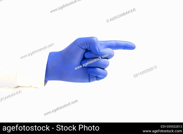 Doctor wearing blue latex Glove and pointing index finger. White background. Copy space