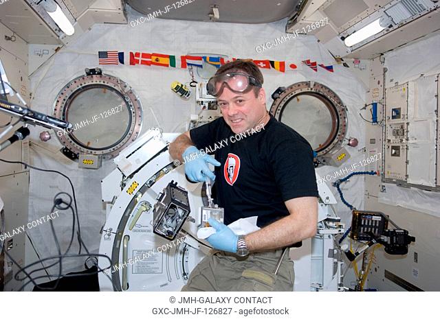 NASA astronaut Ron Garan, Expedition 27 flight engineer, supports the Dynamism of Auxin Efflux Facilitators responsible for Gravity-regulated Growth and...