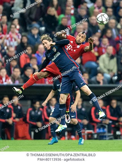 Bayern Munich's Arturo Vidal (red) and Madrid's Fernando Torres in action during the UEFA Champions League semi final soccer match FC Bayern Munich vs Atletico...