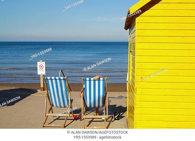 Deckchairs and beach hut at Whitby, North Yorkshire, England, UK