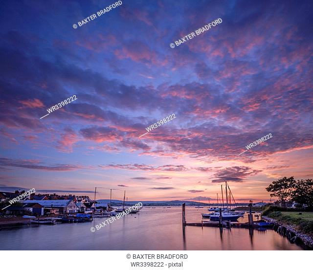 Sunset with boats on the Exe shoreline at the back of Camperdown Terrace, Exmouth, Devon, England, United Kingdom, Europe