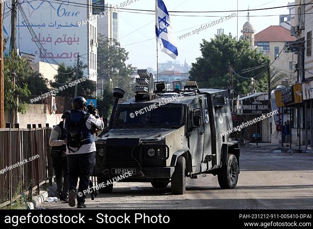 12 December 2023, Palestinian Territories, Jenin: An Israeli military vehicle parks during a raid at the Jenin refugee camp in the occupied West Bank