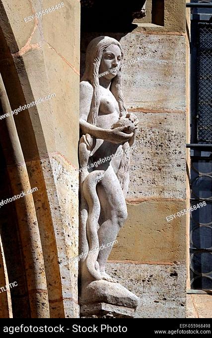 Eve with snake, statue on facade of the St James Church in Rothenburg ob der Tauber, Germany