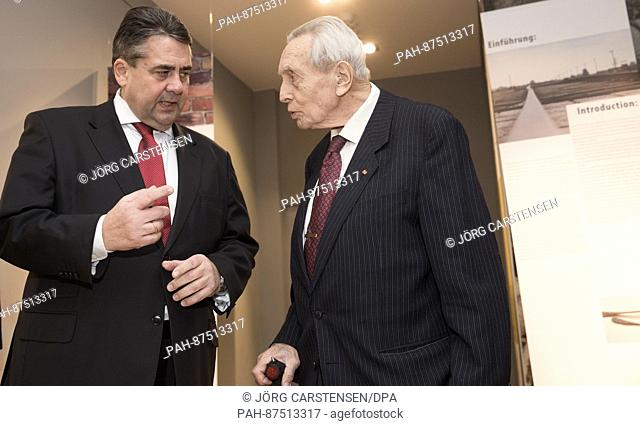 The Holocaust and Auschwitz survivor Felix Kolmer (R) and the Federal Minister of Economy Sigmar Gabriel stand in the exhibition ""Shoes