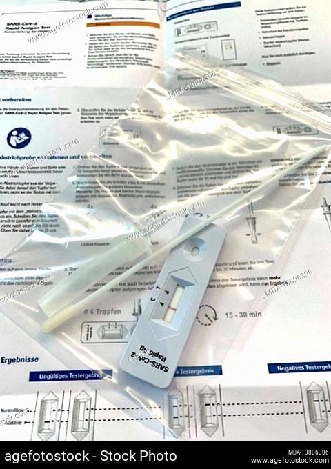A corona rapid test with a negative test result in a plastic bag is on the package insert