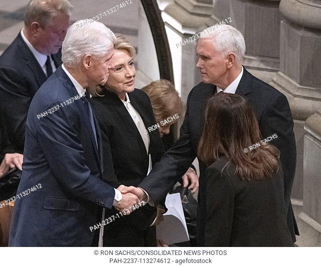 Former United States President Bill Clinton, left, shakes hands with US Vice President Mike Pence, left, as former US Secretary of State Hillary Rodham Clinton
