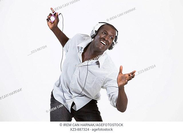 Portrait of a young black man dancing and listening to music