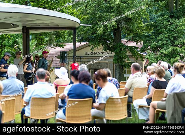 24 June 2023, Saxony, Bad Muskau: Visitors seated at the ceremony marking the 200th anniversary of the Hermannsbad in Bad Muskau