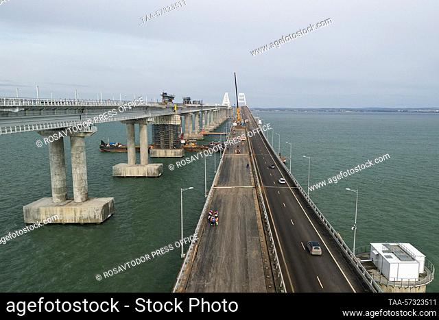 RUSSIA, REPUBLIC OF CRIMEA - FEBRUARY 12, 2023: Paving asphalt on the left side of the motor section of the bridge linking Crimea to mainland Russia; 260 meters...