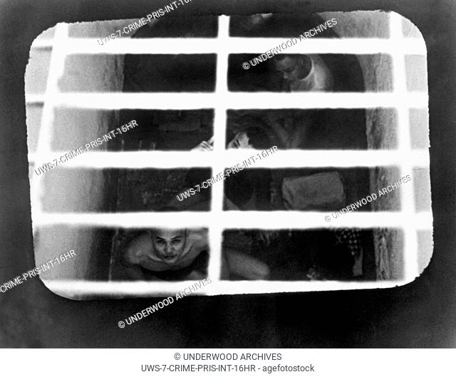 Con Son Island, South Vietnam: July, 1970 South Vietnamese political prisoners peering up from a tiger cage cell in a prison off the South Vietnam coast