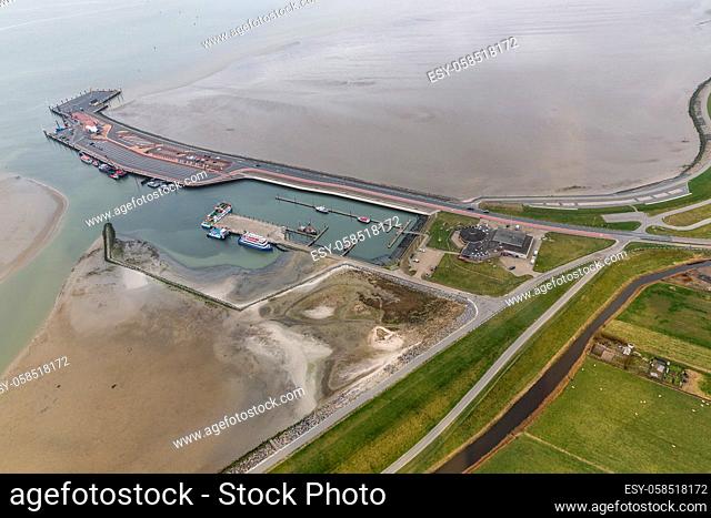 Aerial view ferry terminal with low tide at Dutch island Ameland in Wadden Sea