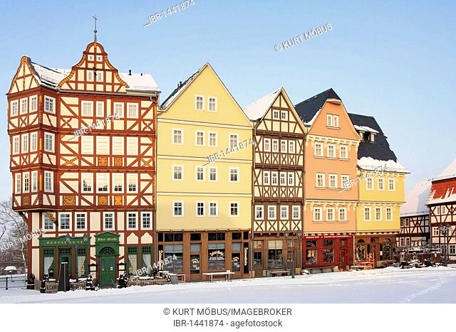 Historic row of houses on the market square in snow in the evening light, winter in Hessenpark, Neu-Anspach, Taunus, Hesse, Germany, Europe