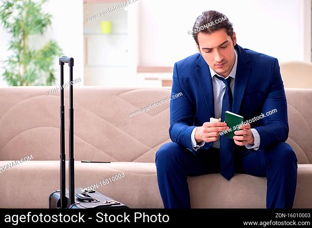 Young businessman holding passport preparing for the trip