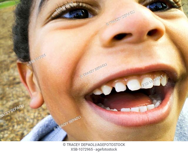 young multiracial boy, laughing joyfully  close up, Horizontal
